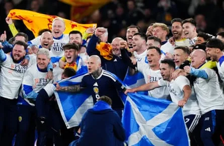 Scotland players and manager Steve Clarke celebrate after they qualified for the 2026 World Cup after beating Denmark 4-2