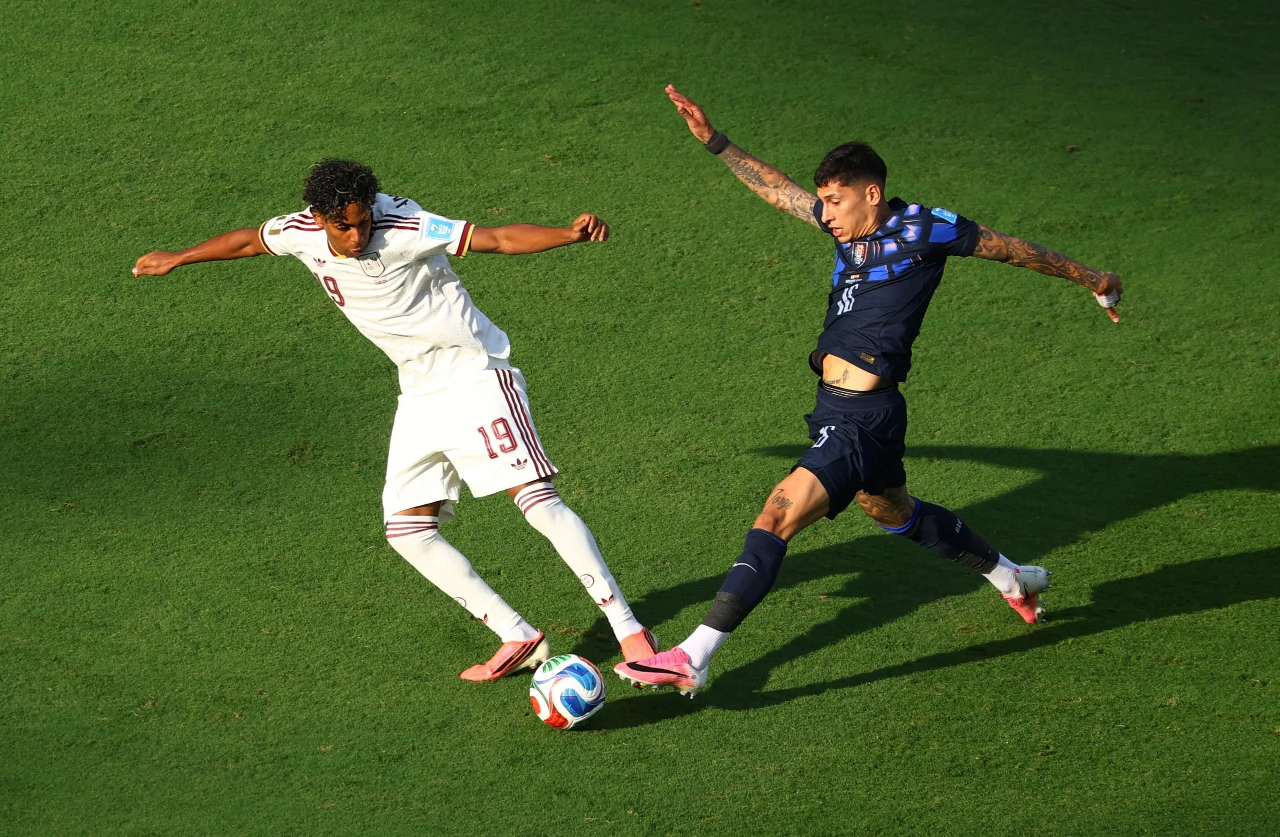 Lamine Yamal nips in ahead of Uruguay's Mathias Olivera.