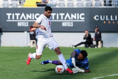 Iran’s Mehdi Taremi (left) attempts to go past Nigeria’s goalkeeper Maduka Okoye during their friendly in March