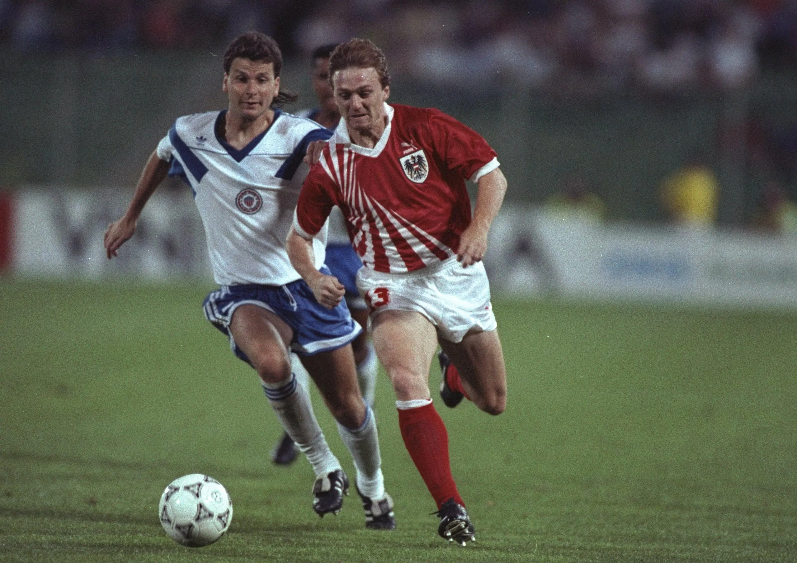 Andreas Ogris runs away from a defender en route to scoring for Austria in their 1990 World Cup match against USA in Florence.