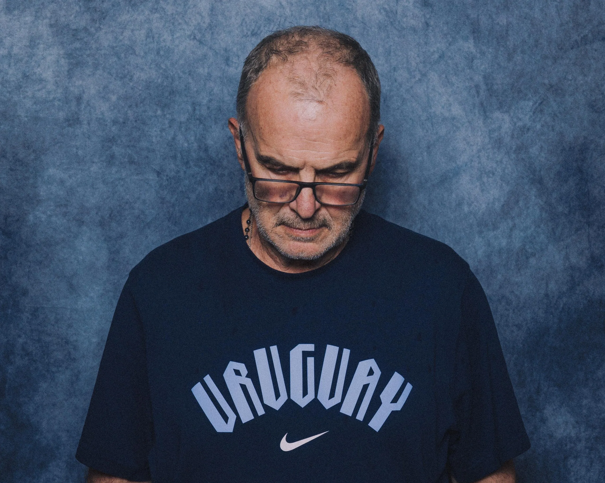 Marcelo Bielsa looks down during his official Fifa portrait photo