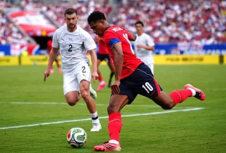 Tim Payne (left) and Jude Bellingham battle for the ball during the friendly between England and New Zealand.