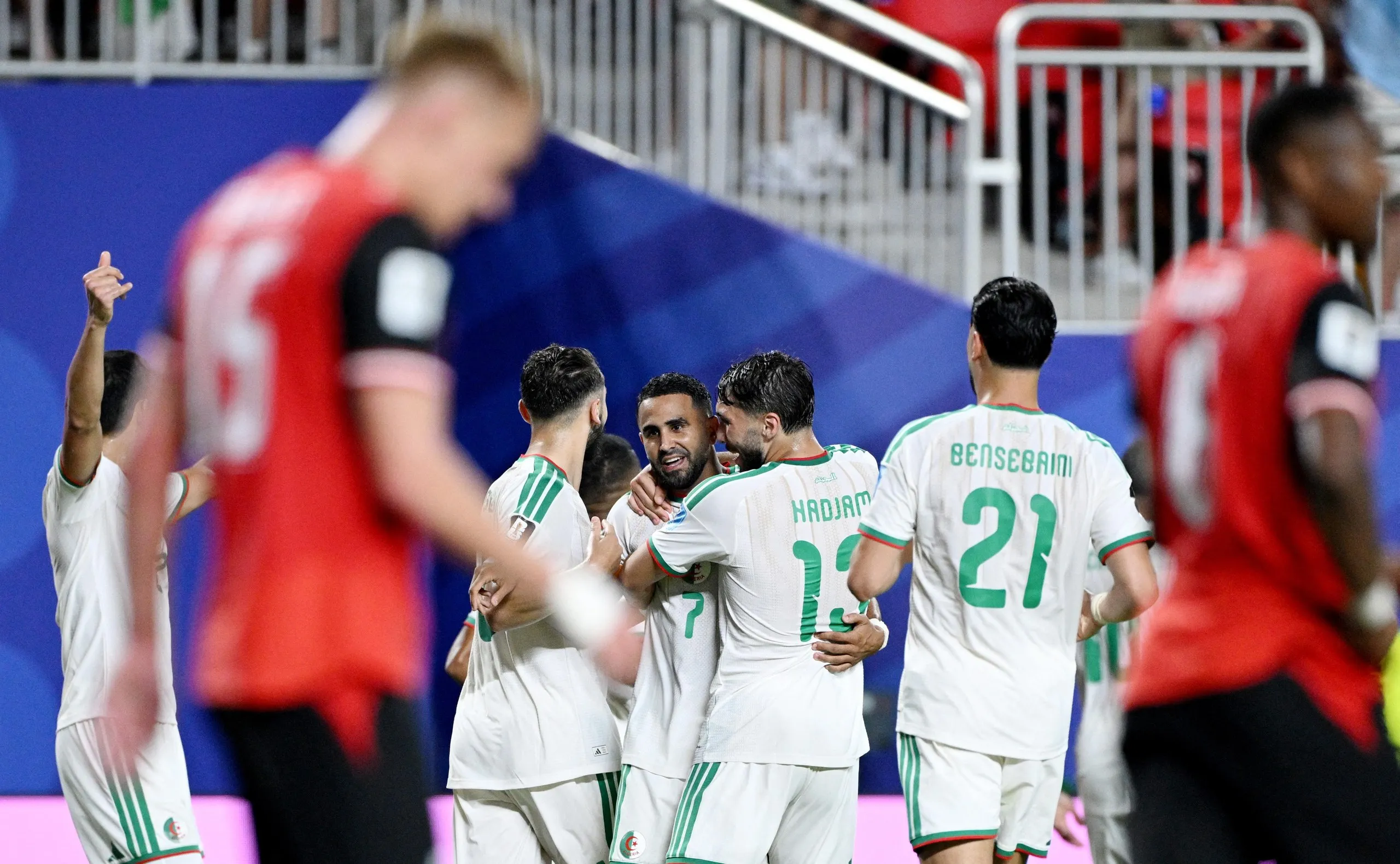 Riyad Mahrez gets mobbed after scoring Algeria’s second.