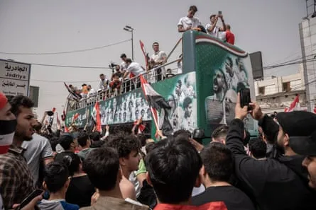 Iraqi national football players arrive on a bus to celebrate their qualification for the World Cup on April 4, 2026 in Baghdad, Iraq.