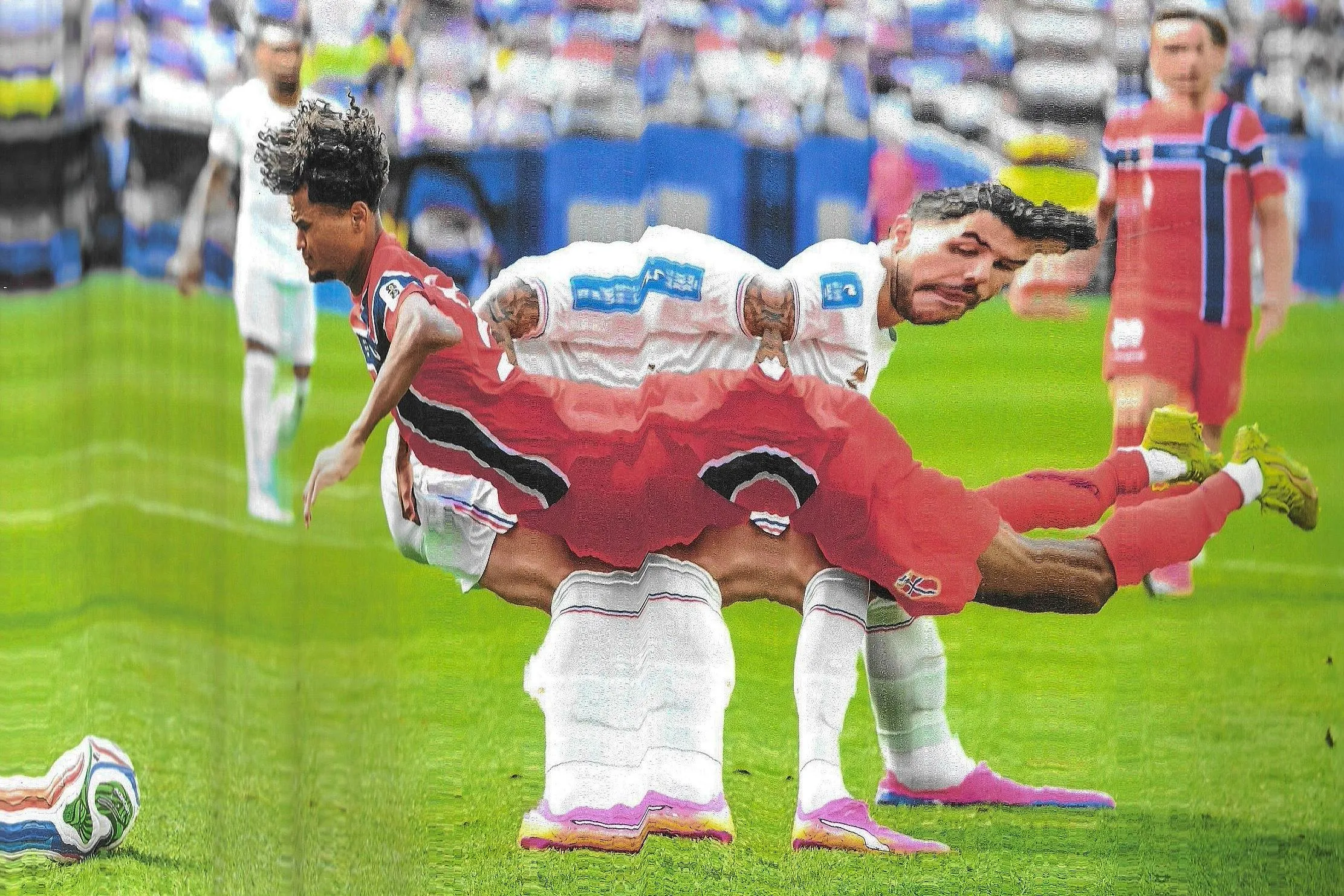 Oscar Bobb of Norway falls over the challenge from Theo Hernandez of France. Original photograph by Harry Langer.