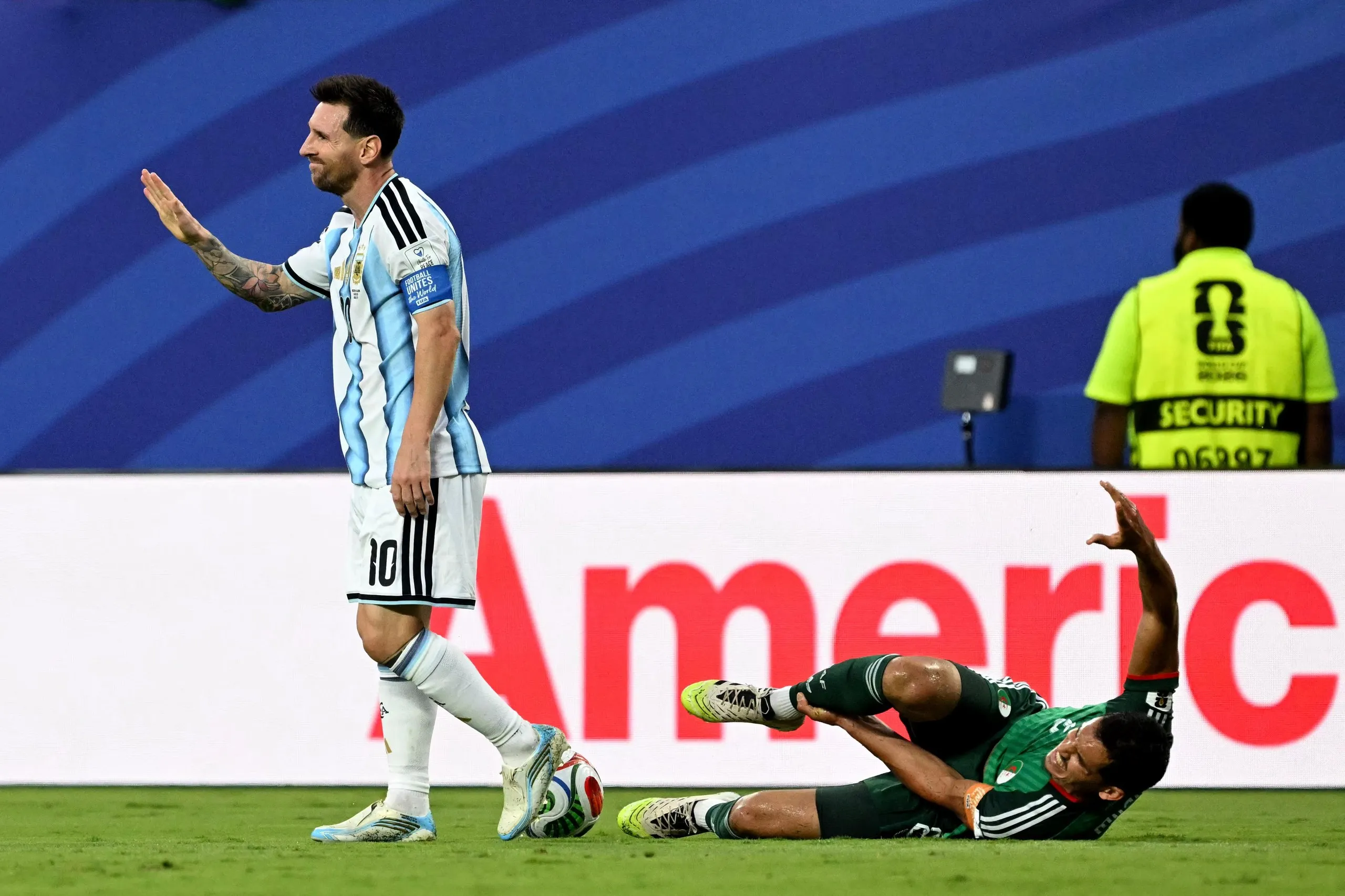 Argentina’s Lionel Messi gestures after a foul on the Algeria defender Aissa Mandi