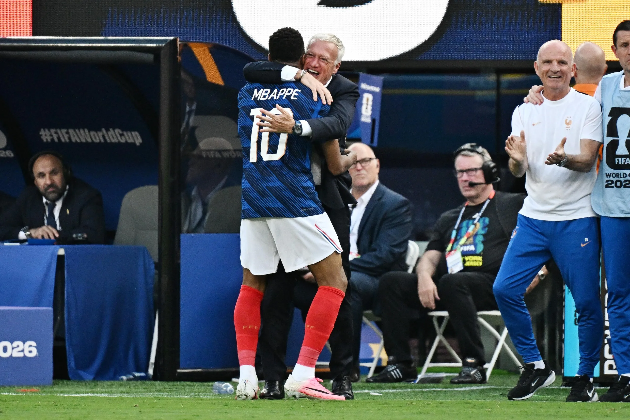 Didier Deschamps is embraced by Kylian Mbappé as France take on Sweden.