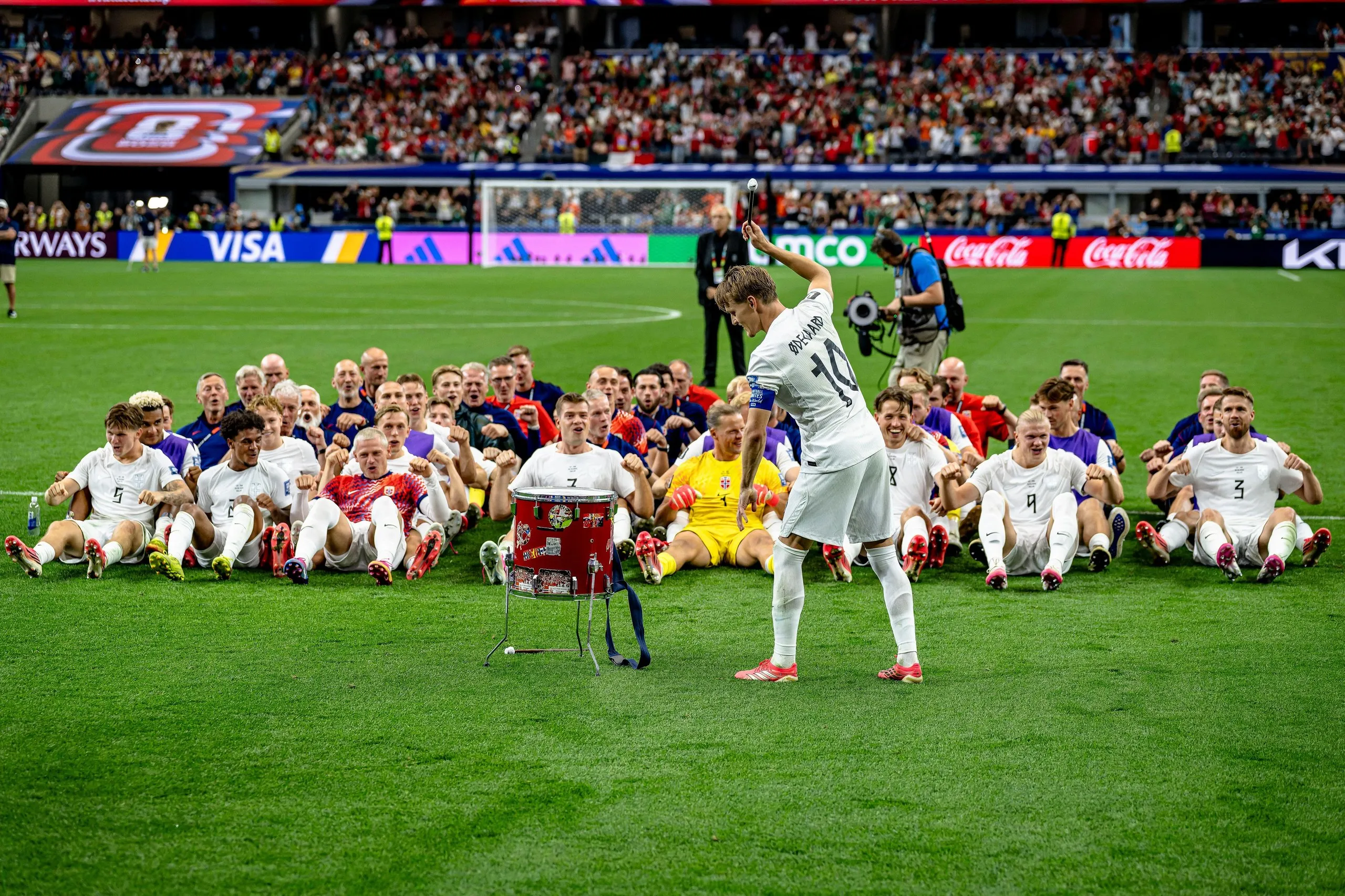 Norway’s players do the Viking row. 