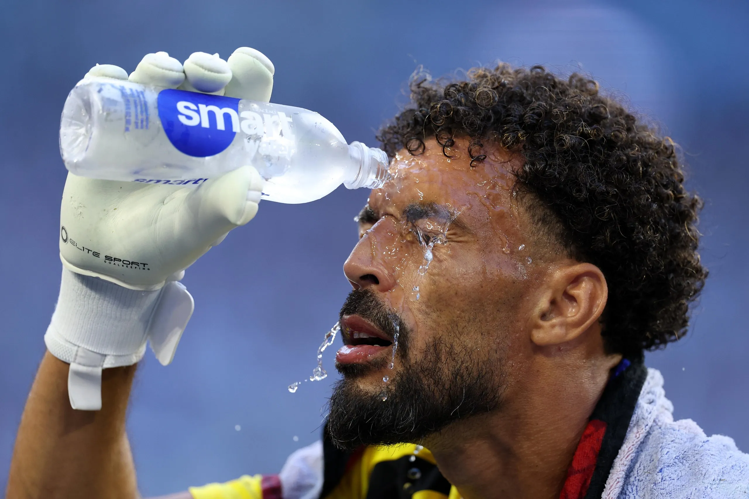 a man pouring water on his face 