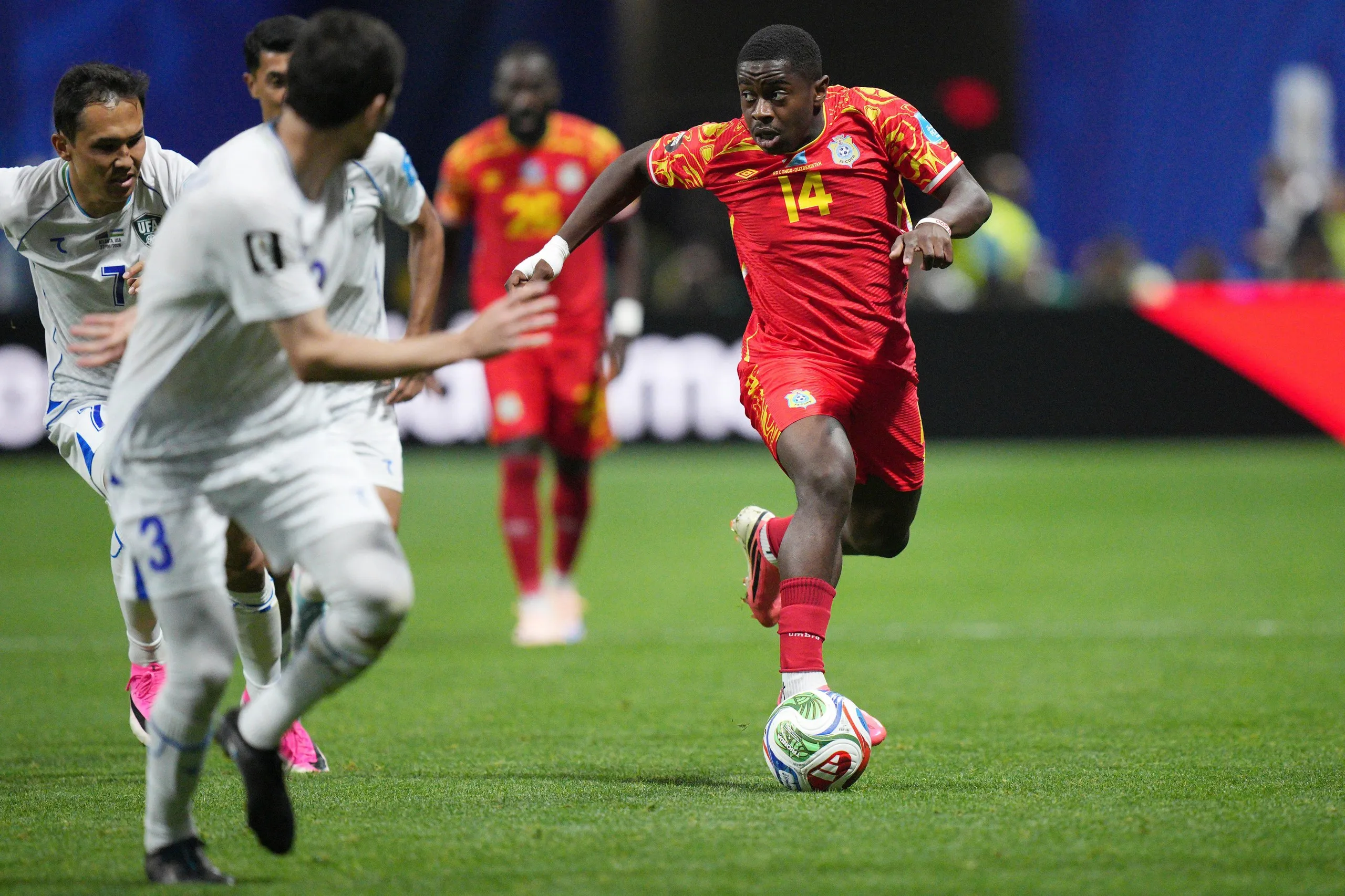 Noah Sadiki dribbles towards a defender